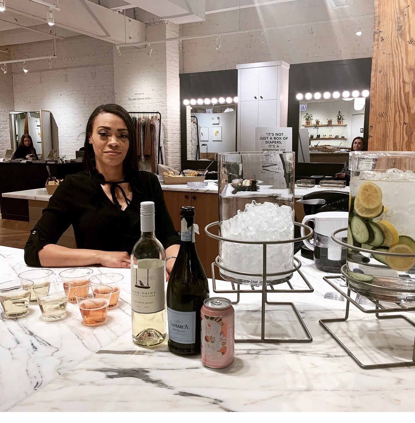 CULTE hospitality team serving at a marble bar activation